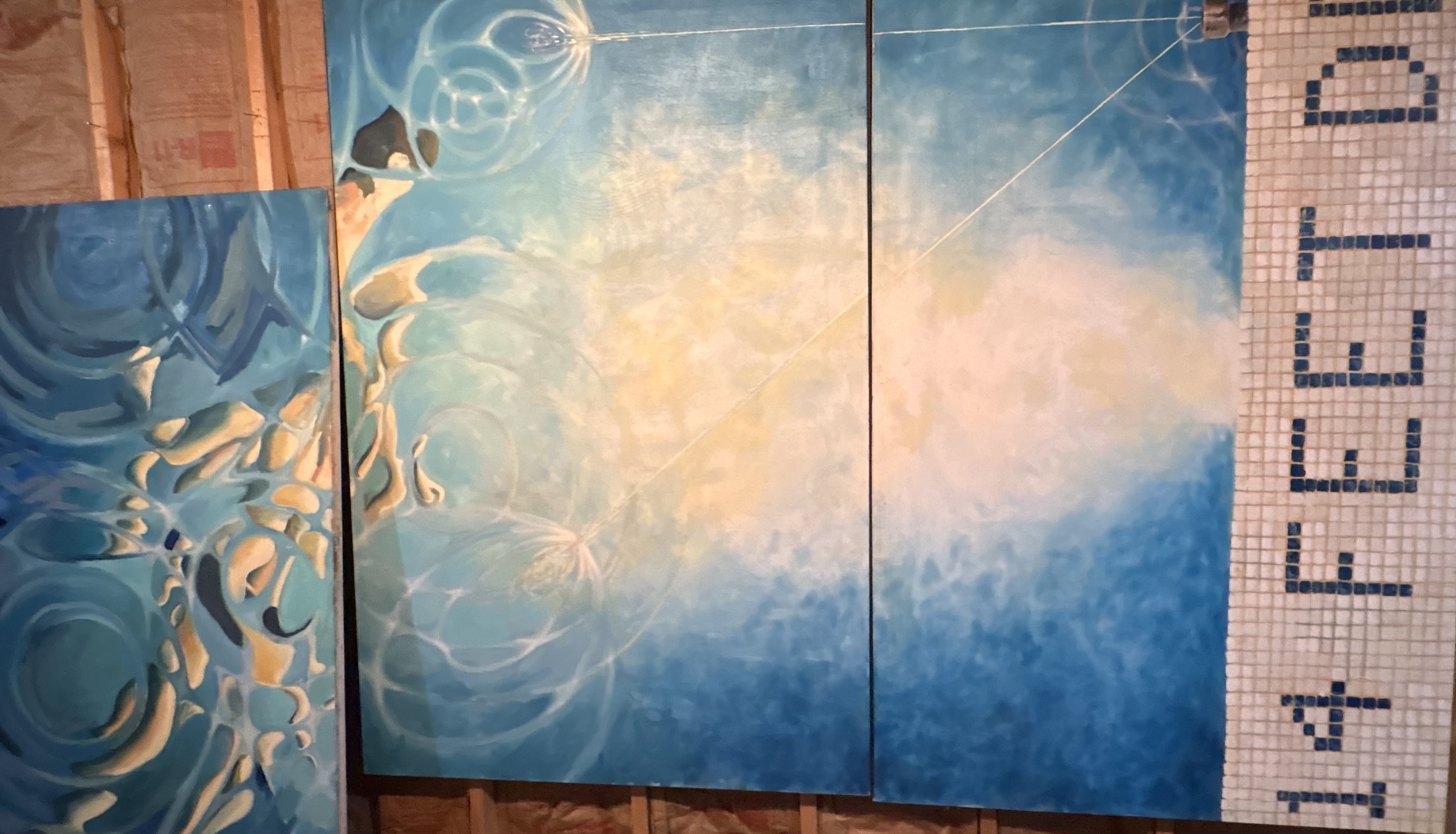 Blue water artwork beside pool tile spelling 14 feet deep